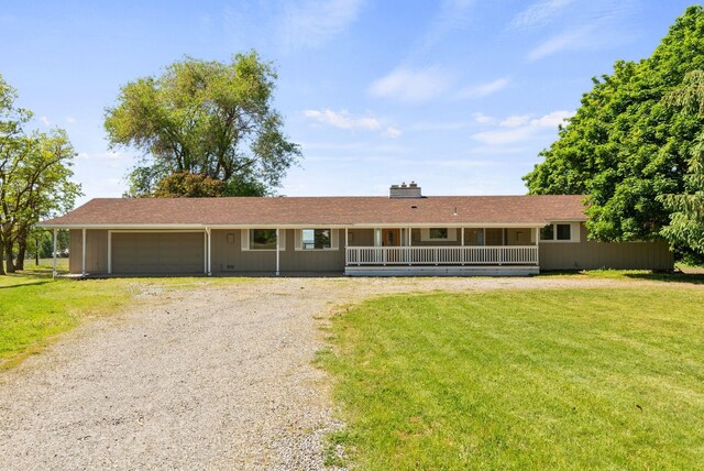 4626 E Orchard Rd, Spokane, WA 99217 - ranch-style home featuring driveway, a front lawn, a garage, and a chimney
