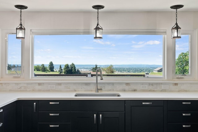 4626 E Orchard Rd, Spokane, WA 99217 - kitchen featuring a sink, healthy amount of natural light, and dark cabinetry