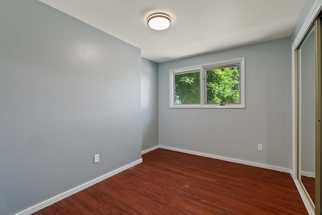 4626 E Orchard Rd, Spokane, WA 99217 - unfurnished bedroom with a closet, dark wood-style flooring, and baseboards