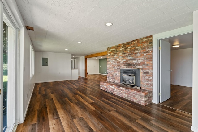 4626 E Orchard Rd, Spokane, WA 99217 - unfurnished living room featuring wood finished floors, electric panel, a wood stove, and recessed lighting