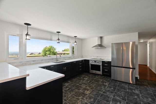 4626 E Orchard Rd, Spokane, WA 99217 - kitchen featuring stainless steel appliances, a sink, wall chimney exhaust hood, dark cabinets, and decorative light fixtures