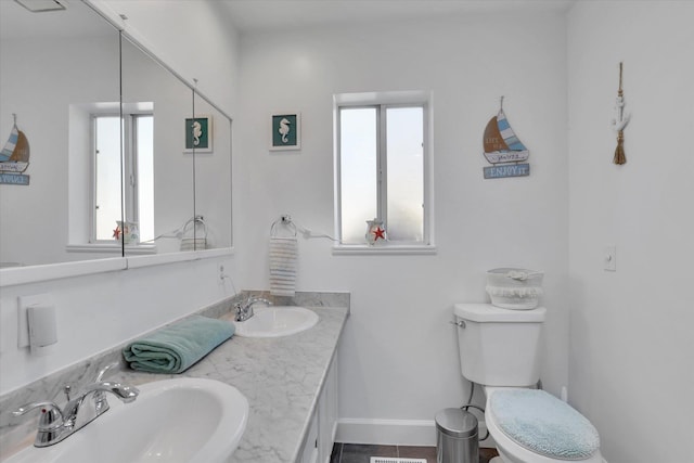 4606 S Grove Rd, Spokane, WA 99224 - bathroom with toilet, double vanity, baseboards, and tile patterned floors