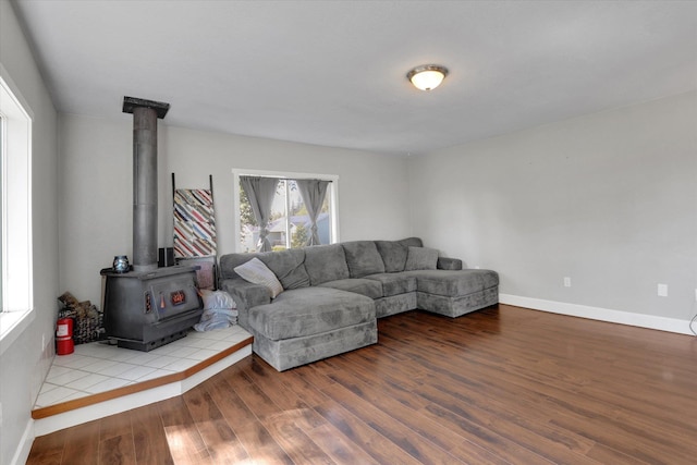 4606 S Grove Rd, Spokane, WA 99224 - living room featuring a wood stove, wood finished floors, and baseboards
