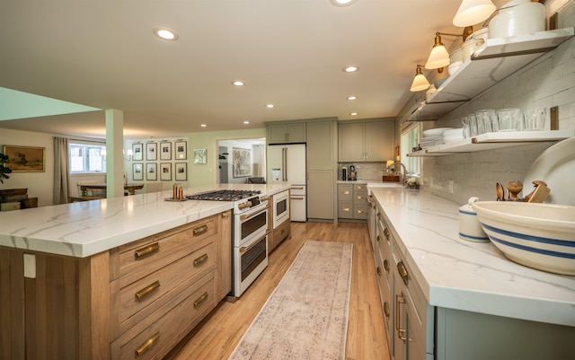 19009 N Little Spokane Dr, Colbert, WA 99005 - kitchen featuring high quality appliances, light wood-type flooring, a sink, a spacious island, and recessed lighting