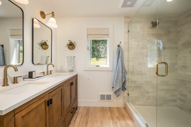 19009 N Little Spokane Dr, Colbert, WA 99005 - full bathroom featuring double vanity, wood finished floors, a shower stall, and baseboards