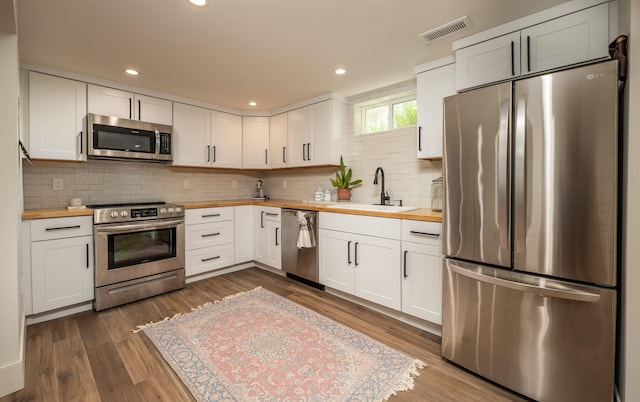 19009 N Little Spokane Dr, Colbert, WA 99005 - kitchen with stainless steel appliances, wooden counters, a sink, dark wood-style flooring, and recessed lighting