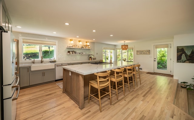 19009 N Little Spokane Dr, Colbert, WA 99005 - kitchen with refrigerator, a sink, a kitchen breakfast bar, recessed lighting, and a kitchen island