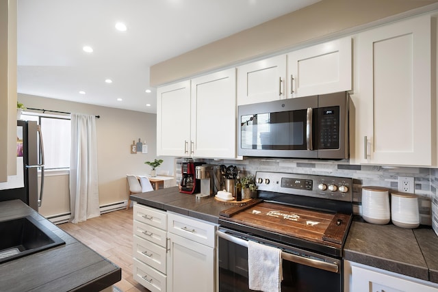 1641 E Crown Ave, Spokane, WA 99207 - kitchen with stainless steel appliances, white cabinetry, dark countertops, and recessed lighting