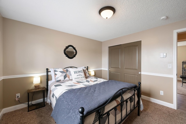 1641 E Crown Ave, Spokane, WA 99207 - bedroom with carpet flooring, a closet, a textured ceiling, and baseboards
