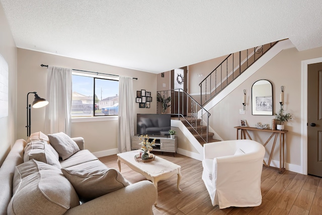 1641 E Crown Ave, Spokane, WA 99207 - living area featuring a textured ceiling, light wood finished floors, stairway, and baseboards