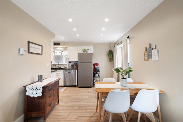 1641 E Crown Ave, Spokane, WA 99207 - dining space featuring light wood-type flooring, recessed lighting, and a textured ceiling