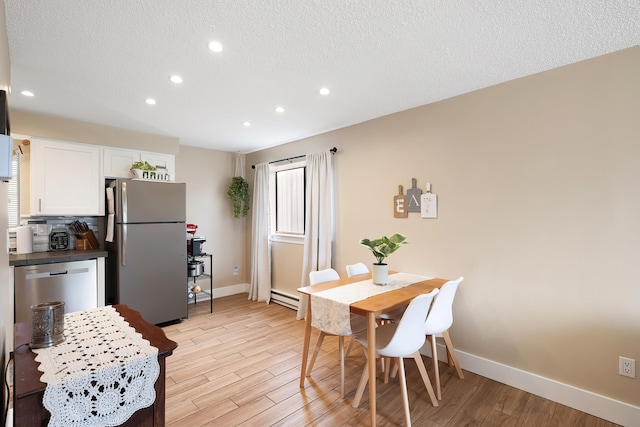 1641 E Crown Ave, Spokane, WA 99207 - dining area with baseboards, recessed lighting, light wood-type flooring, a textured ceiling, and a baseboard heating unit