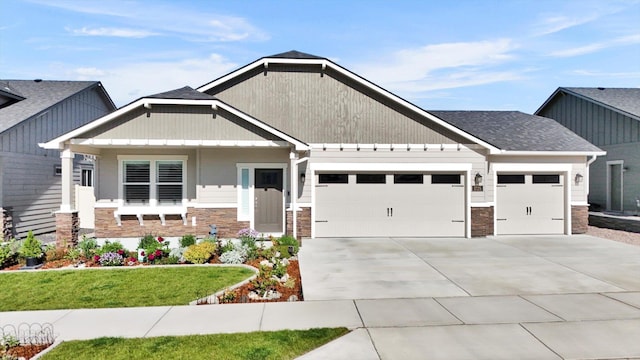 1725 S Donwood St, Spokane Valley, WA 99037 - craftsman inspired home with stone siding, a garage, concrete driveway, a front yard, and a shingled roof