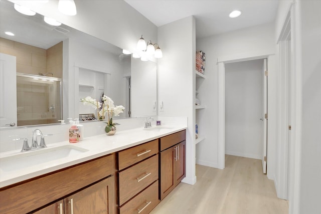 1725 S Donwood St, Spokane Valley, WA 99037 - full bathroom featuring a shower stall, double vanity, wood finished floors, a walk in closet, and recessed lighting