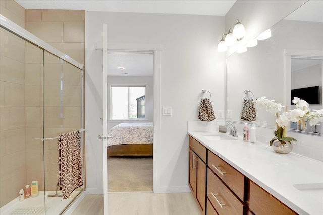 1725 S Donwood St, Spokane Valley, WA 99037 - full bath featuring ensuite bathroom, double vanity, a shower stall, wood finished floors, and baseboards