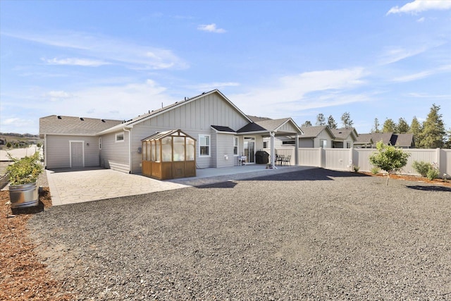 1725 S Donwood St, Spokane Valley, WA 99037 - rear view of house with a patio, board and batten siding, and a sunroom
