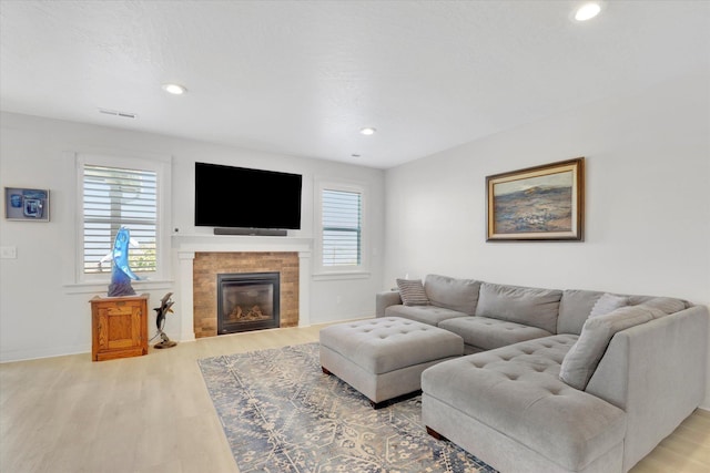 1725 S Donwood St, Spokane Valley, WA 99037 - living area featuring wood finished floors, plenty of natural light, recessed lighting, a tile fireplace, and baseboards