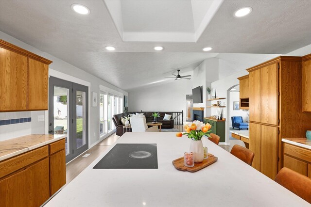 10102 N Comanche Dr, Spokane, WA 99208 - kitchen with black electric stovetop, light countertops, recessed lighting, ceiling fan, and brown cabinets