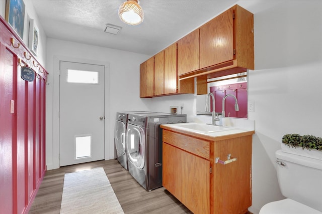 10102 N Comanche Dr, Spokane, WA 99208 - laundry room with washer and clothes dryer and light wood-style floors