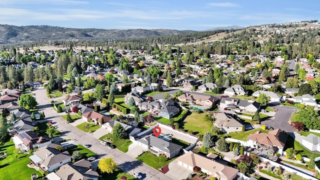 10102 N Comanche Dr, Spokane, WA 99208 - aerial overview of property's location featuring a mountain backdrop and nearby suburban area