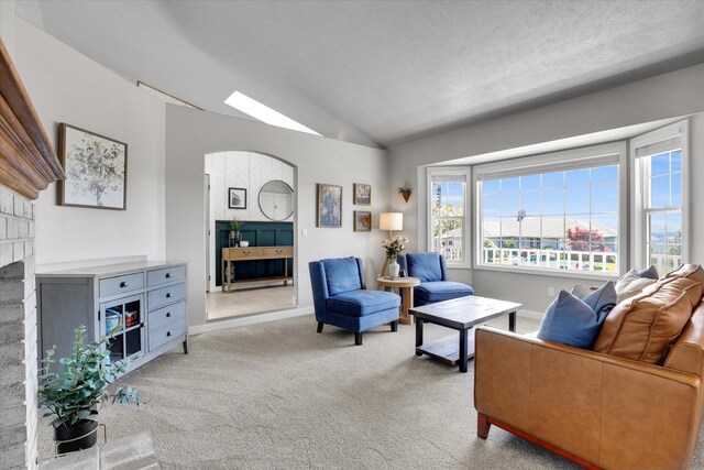 10102 N Comanche Dr, Spokane, WA 99208 - living area with carpet, lofted ceiling, and a fireplace