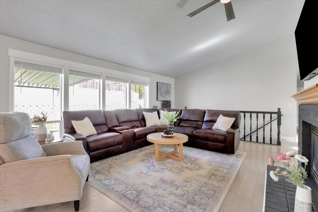 10102 N Comanche Dr, Spokane, WA 99208 - living area featuring lofted ceiling, a ceiling fan, wood finished floors, and a fireplace