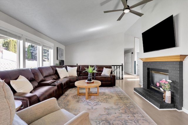 10102 N Comanche Dr, Spokane, WA 99208 - living area with ceiling fan, wood finished floors, high vaulted ceiling, a fireplace, and baseboards