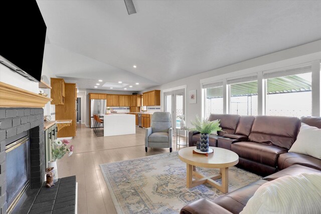 10102 N Comanche Dr, Spokane, WA 99208 - living room with vaulted ceiling, recessed lighting, a brick fireplace, and light wood-type flooring