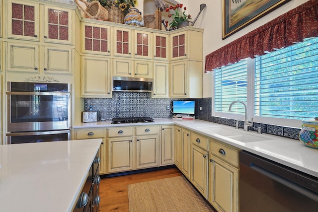 5711 E Nancy Ln, Mead, WA 99021 - kitchen with cream cabinets, appliances with stainless steel finishes, a sink, and light countertops