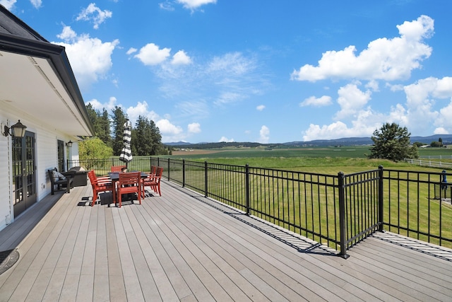 5711 E Nancy Ln, Mead, WA 99021 - wooden deck with outdoor dining area, a view of countryside, and a yard