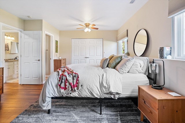 1725 N Mcmillan Ln, Spokane Valley, WA 99016 - bedroom featuring wood finished floors, a closet, connected bathroom, and ceiling fan