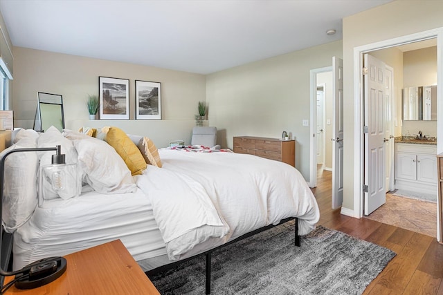 1725 N Mcmillan Ln, Spokane Valley, WA 99016 - bedroom featuring dark wood-style flooring, connected bathroom, a sink, and baseboards