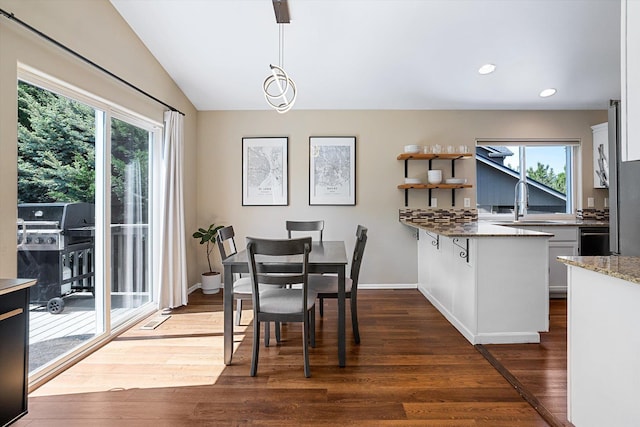 1725 N Mcmillan Ln, Spokane Valley, WA 99016 - dining room featuring healthy amount of natural light, dark wood-type flooring, recessed lighting, vaulted ceiling, and baseboards