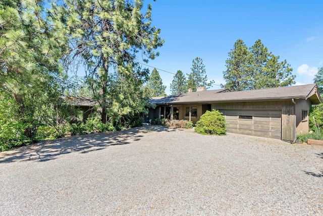 2616 S SE Blvd Unit 2606, Spokane, WA 99223 - view of front of home featuring gravel driveway, a garage, and a chimney