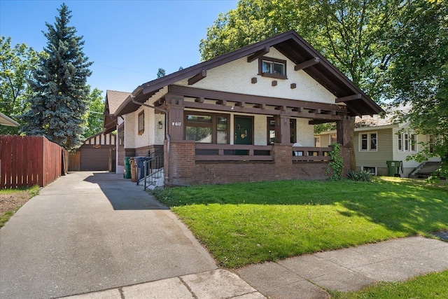 617 W Carlisle Ave, Spokane, WA 99205 - view of front of home with brick siding, an outdoor structure, and a detached garage