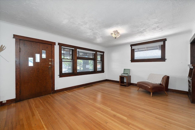 617 W Carlisle Ave, Spokane, WA 99205 - foyer with a textured ceiling, light wood-style flooring, and baseboards