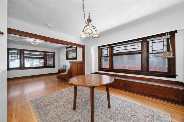617 W Carlisle Ave, Spokane, WA 99205 - dining space featuring wood finished floors, baseboards, and a chandelier