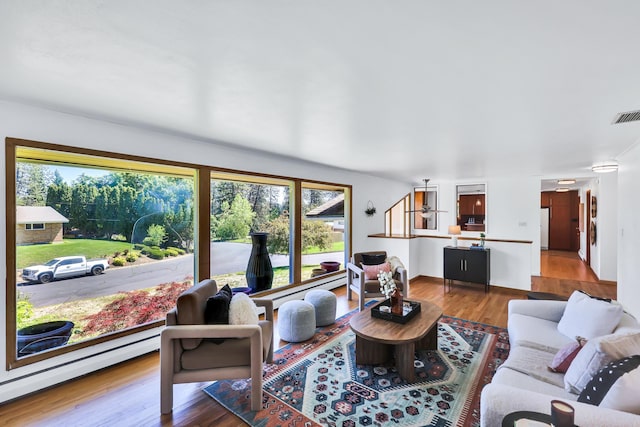 10401 N College Cir, Spokane, WA 99218 - living room featuring plenty of natural light, a baseboard radiator, and wood finished floors