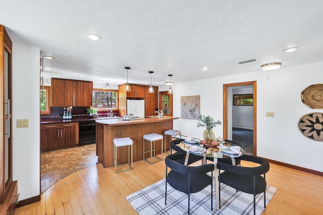10401 N College Cir, Spokane, WA 99218 - dining area with baseboards, light wood-type flooring, recessed lighting, and baseboard heating