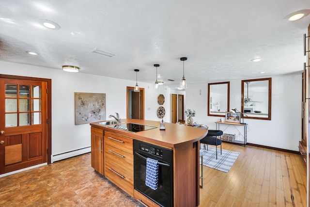 10401 N College Cir, Spokane, WA 99218 - kitchen featuring black appliances, a baseboard heating unit, a sink, pendant lighting, and a kitchen island with sink