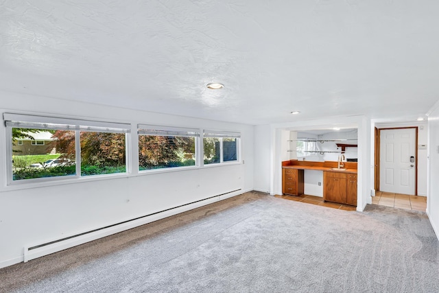 10401 N College Cir, Spokane, WA 99218 - unfurnished living room with a baseboard radiator, light colored carpet, and a sink