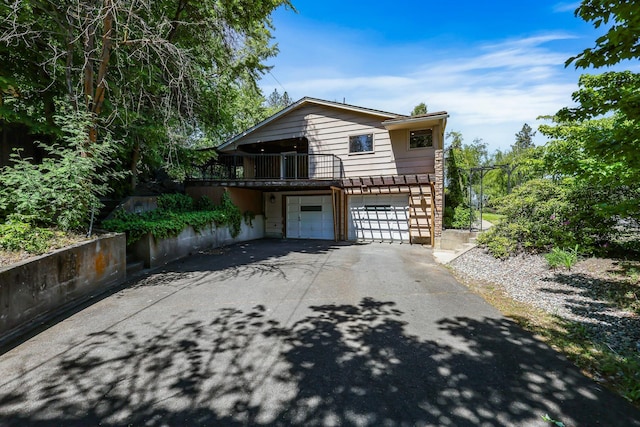 10401 N College Cir, Spokane, WA 99218 - view of front of house featuring asphalt driveway and an attached garage