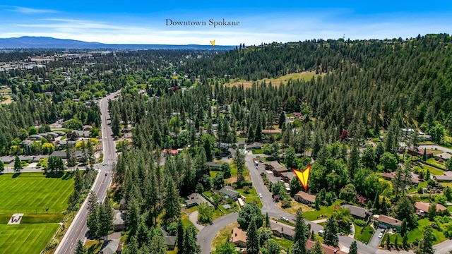 10401 N College Cir, Spokane, WA 99218 - aerial overview of property's location with a heavily wooded area and mountains
