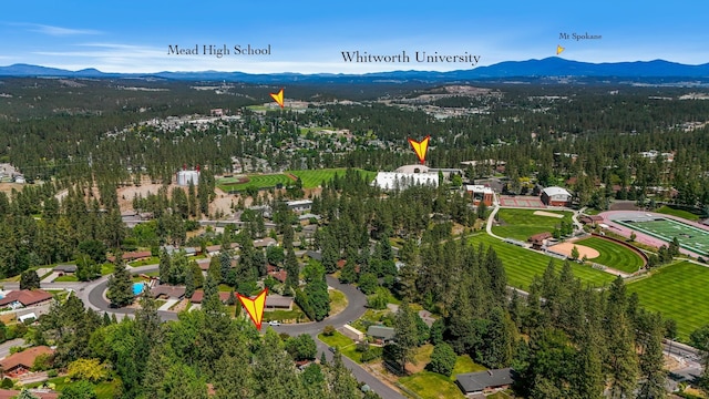 10401 N College Cir, Spokane, WA 99218 - aerial view of property's location with a mountain backdrop and a forest