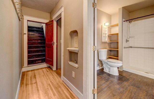 18 N 7th St, Cheney, WA 99004 - bathroom featuring wood finished floors, toilet, and a shower