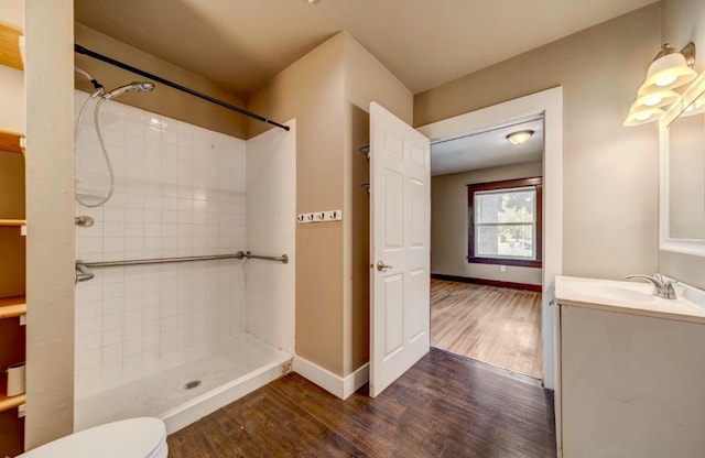 18 N 7th St, Cheney, WA 99004 - bathroom with wood finished floors, vanity, and tiled shower