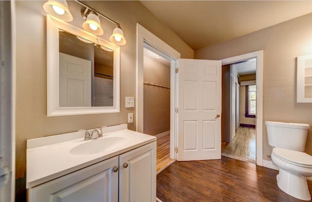 18 N 7th St, Cheney, WA 99004 - full bath featuring wood finished floors, vanity, toilet, and baseboards