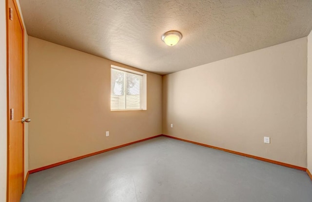 18 N 7th St, Cheney, WA 99004 - spare room featuring finished concrete flooring, baseboards, and a textured ceiling