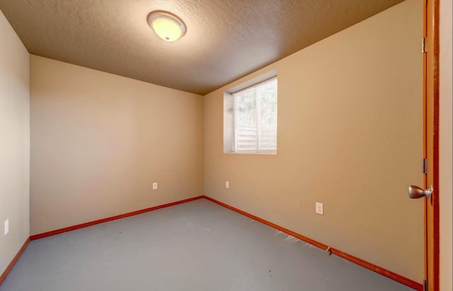 18 N 7th St, Cheney, WA 99004 - unfurnished room with a textured ceiling, finished concrete flooring, and baseboards