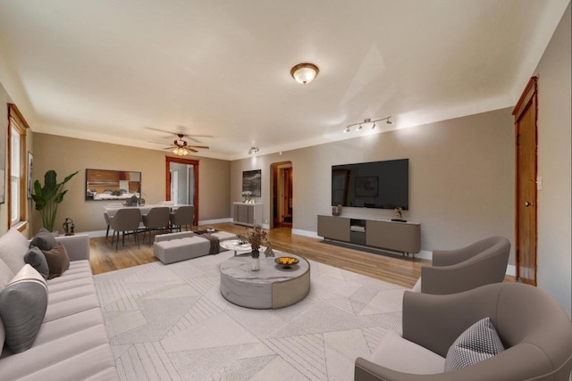 18 N 7th St, Cheney, WA 99004 - living room featuring wood finished floors, a ceiling fan, and baseboards